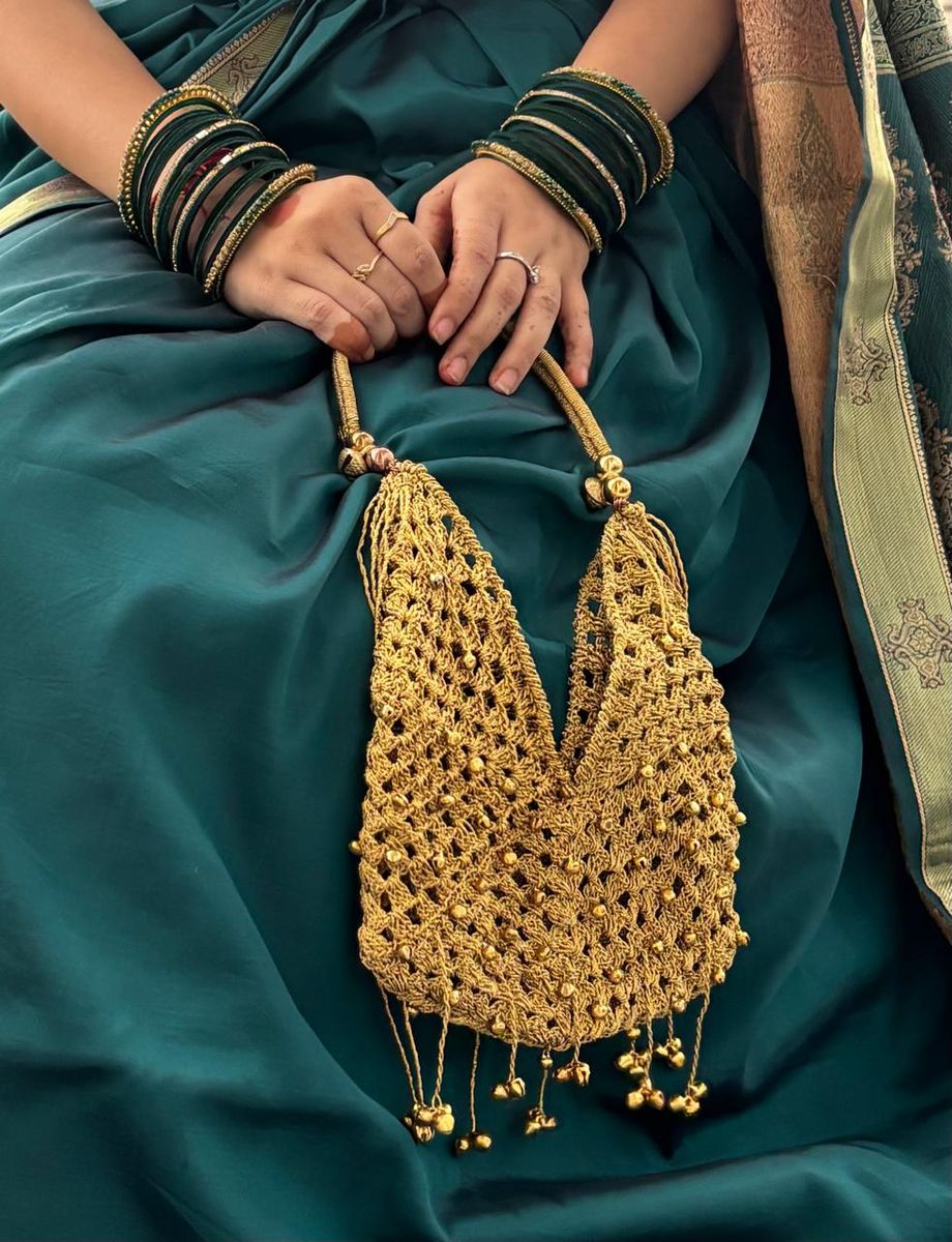Gold crochet bag with saree